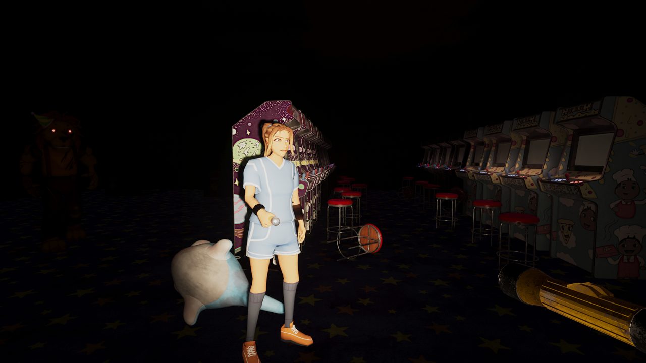 A teen with a flashlight in a dark arcade, a plush dolphin on the floor and cabinets along the wall
